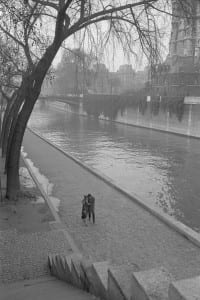 A_couple_walking_along_the_Seine_River_in_Paris